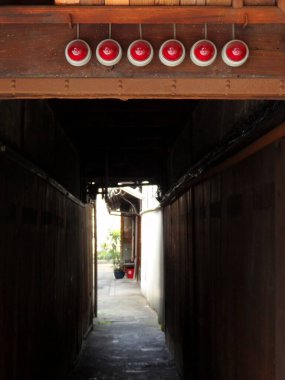 Kırmızı fenerler ve ahşap duvarlarla dar sokaklar