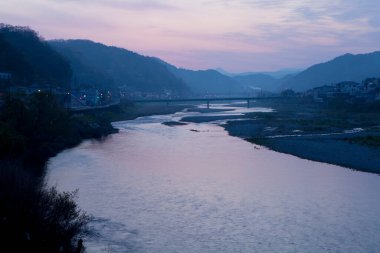 view of the bridge in the river at the sunset 