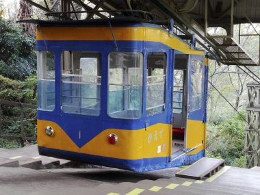 Sarı mavi teleferik dağ istasyonunda bekliyor.