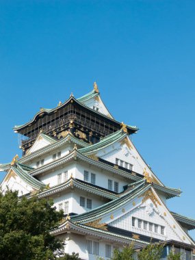 bottom view of Osaka Castle and sunny blue sky clipart