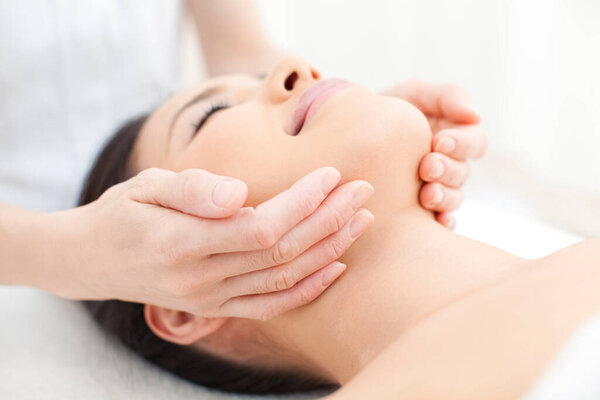 asian woman getting head massage,relaxing in a spa