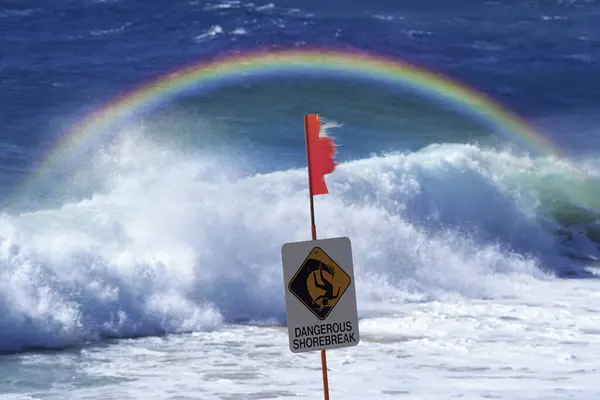 rainbow and waves on a beach, australia. rainbow and waves