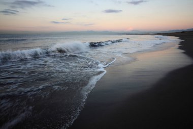 Deniz kıyısında güzel bir gün batımı manzarası.        