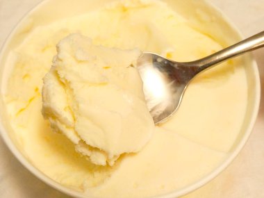 Scooping creamy vanilla ice cream
