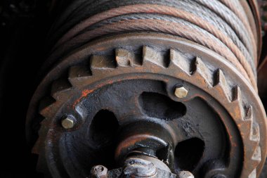 Yakın plan, paslı endüstriyel teçhizatı ve kalın metal kabloları gösteriyor.