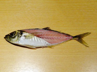 Raw Fish Cut in Half Showing Flesh and Bones on Wooden Background for Cooking Preparation