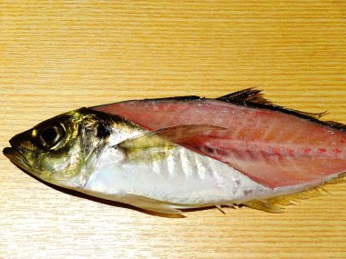 Raw Fish Cut in Half Showing Flesh and Bones on Wooden Background for Cooking Preparation