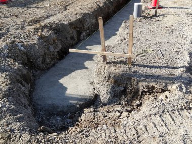 İnşaat alanı yeni dökülmüş beton temelleri gösteriyor