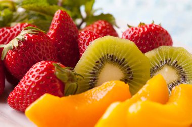 çilekli meyve tabağı, şeftali turşusu ve kivi.