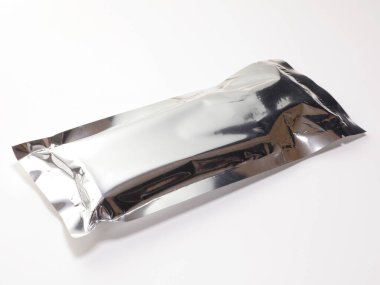 Shiny silver foil packaging lying flat