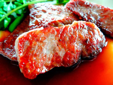 grilled meat with sauce on white plate