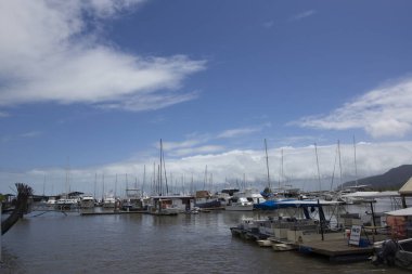 Bulutlu Mavi Gök 'ün altında limana yanaşmış sayısız yelkenli ve yat
