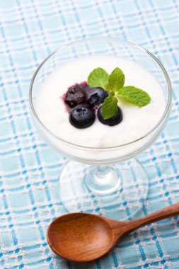 Yoğurtlu yaban mersini ve bardakta nane yaprağı.