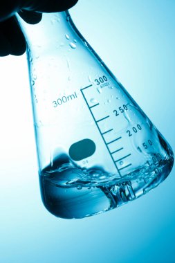 Laboratuvar bardakları ve bilim araştırmalarıyla el ele tutuşmak.