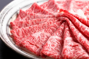 Tabaktaki lezzetli wagyu sığır eti dilimlerinin yakın görüntüsü        