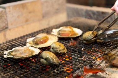 Açık ateşte ızgara midye ve deniz tarağı.