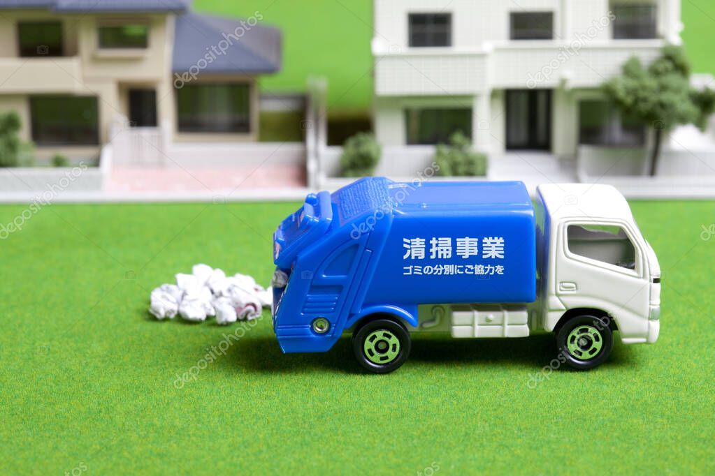 miniature garbage truck collecting trash near house models
