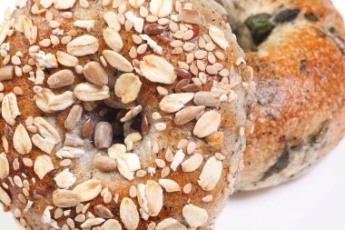 Two multigrain bagels topped with oats and seeds