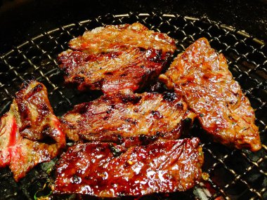 Izgarada pişen taze etin yakın plan görüntüsü.       