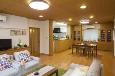 Konforlu evinde ahşap dolapları ve yemek alanı olan bir mutfak.