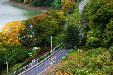 beautiful autumn scenery of road at the lake 