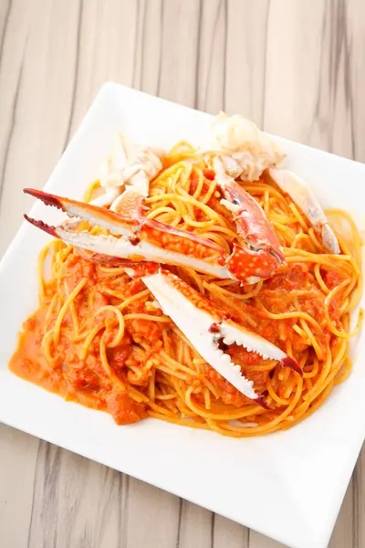 a cuisine photo of pasta with crabs on background, close up