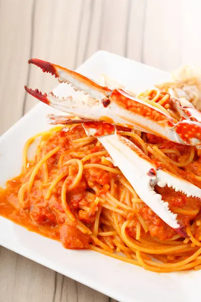 a cuisine photo of pasta with crabs on background, close up