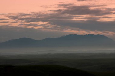 Güzel günbatımı gökyüzü manzaralı dağların üzerinde    