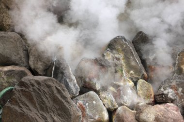 Steam rising from rocky surface