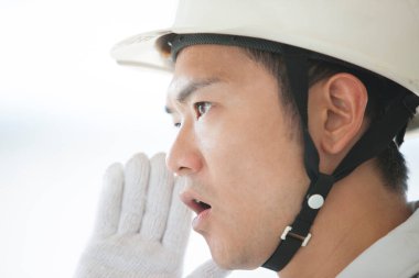 İnşaat alanındaki yakışıklı genç Asyalı mimarın portresi.