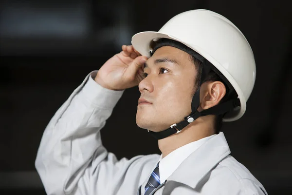 handsome asian engineer in uniform at building construction
