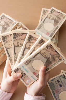 Japon parası tutan kadın elleri, yeni banknotlar
