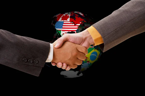 two men shaking hands over a globe with a flags