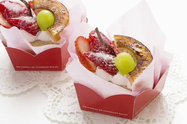 pastry with fruits and cream in boxes