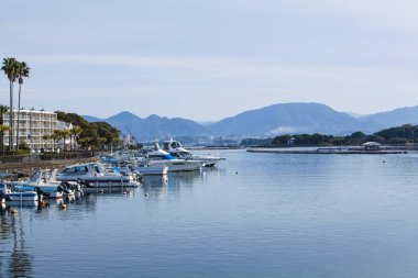 Deniz manzaralı tekneler dağ manzaralı.