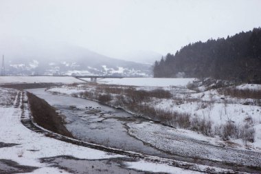 Dağları karla kaplı bir nehir. 