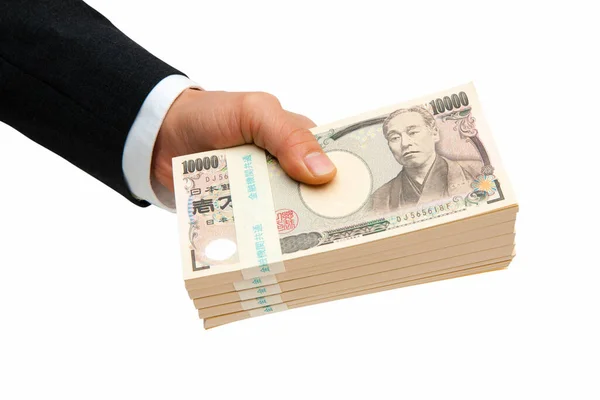 日本のお金を持っている男性の手 白い背景に孤立した円紙幣 — ストック写真
