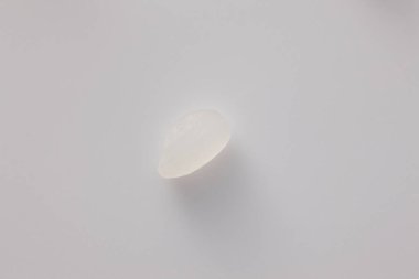 Beyaz arkaplanda beyaz pirinç taneleri.