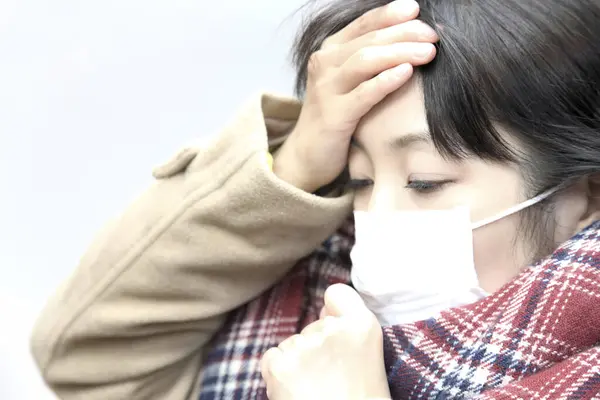 asian woman with mask has a  flu