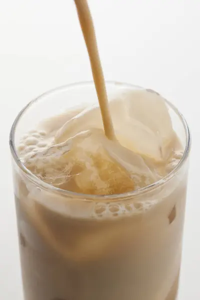 Glass Coffee Pouring Milk Ice Stock Picture