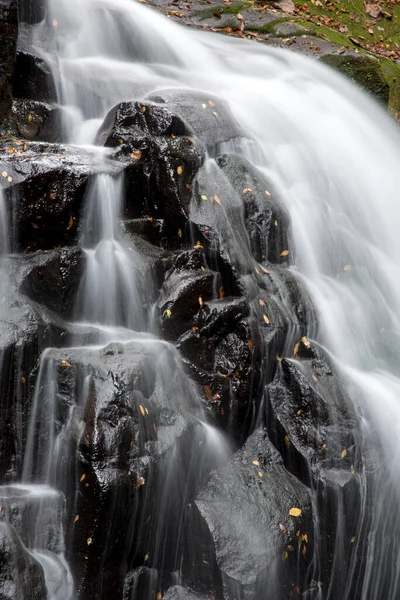 waterfall with black stones, beautiful nature background