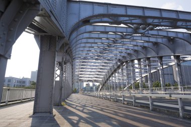 Metal köprü yapısı yürüme yolunda gölgeler bırakıyor