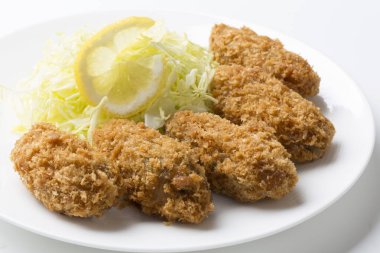 Tavuklu nugget, lahana ve limon tabakta.