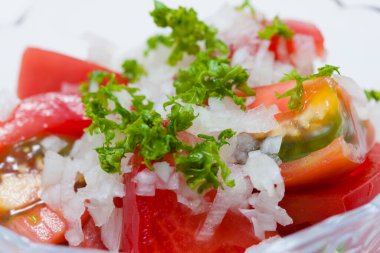 Domatesli salata ve kasede yeşillikler.