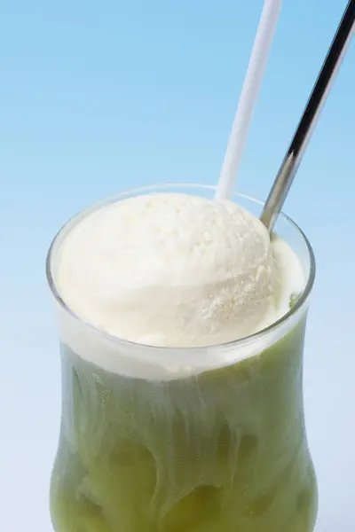 green milk ice cream in a tall cup on the table