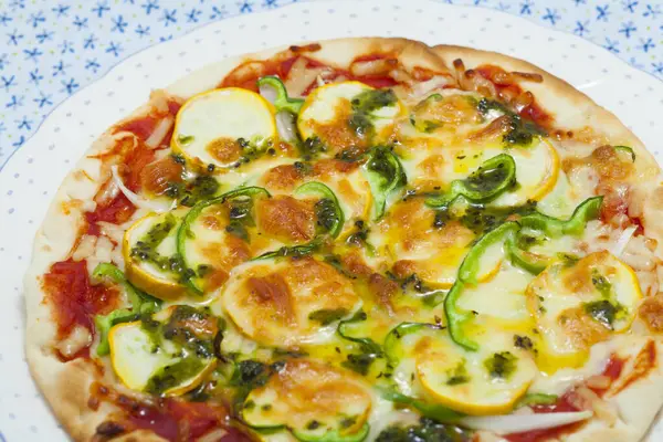 pizza with zucchini and cheese on a plate