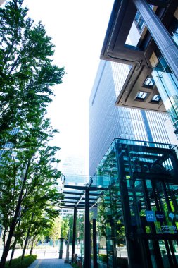 Şehirde yeşil ağaçları olan modern bir bina. 