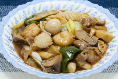 Lezzetli Asya yemeklerini yakından görmek, kızarmış deniz ürünlerini karıştırmak.