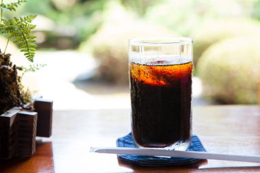 Enjoying refreshing cold beverage on table