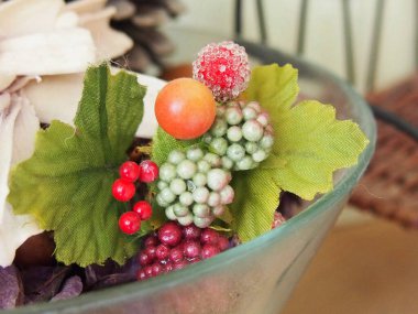 Colorful artificial fruits and leaves arrangement